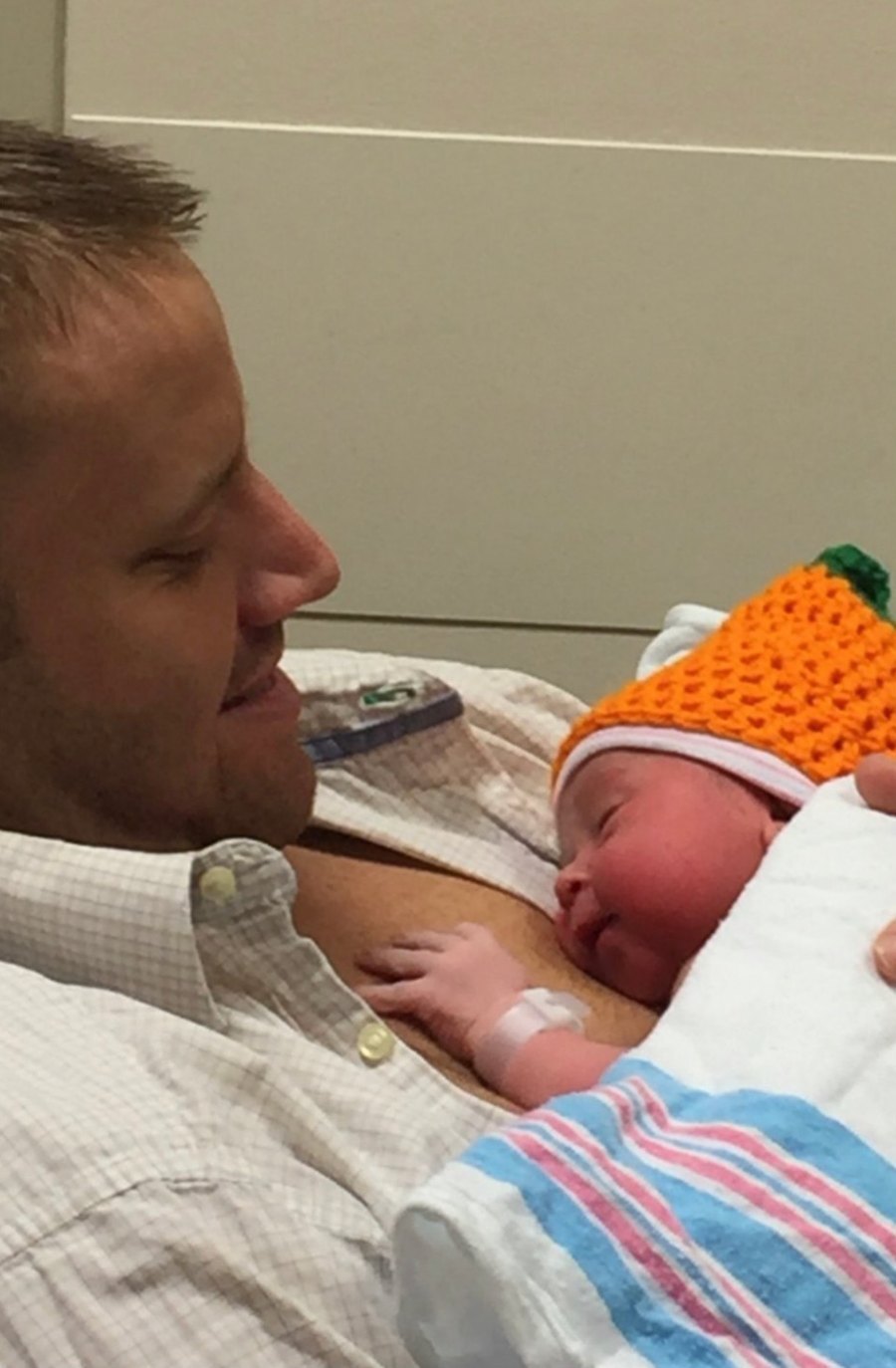 A father holding his newborn daughter against his chest